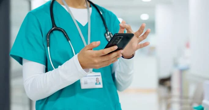 Nurse reviewing patient blood management guidance on her phone